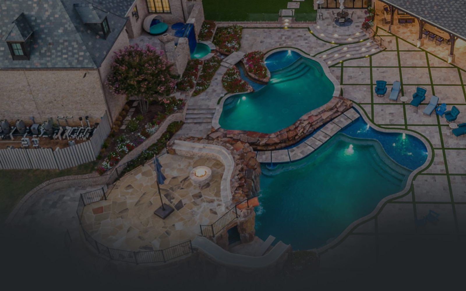 Custom luxury pool and spa design with modern tile in a Dallas backyard